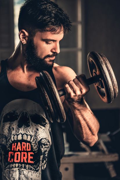 muscular man lifting weights in a gym